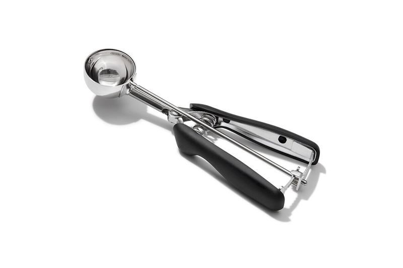 Cuchara para helados y galletas negro acero inox OXO, vista lateral completa con mango ergonómico negro y cuerpo metálico