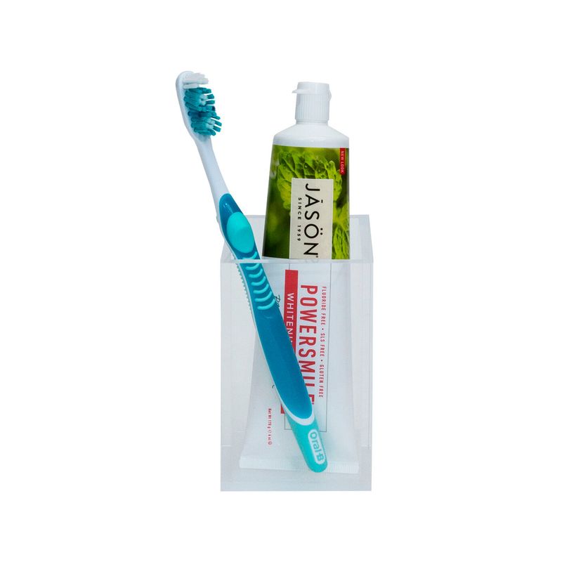 Portacepillo de dientes blanco Metropolis Sttelli, con un cepillo de dientes azul y un tubo de pasta dental blanco
