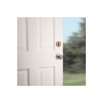 Cerradura pichel Belleview llave/mariposa bronce antiguo Kwikset, instalada en puerta blanca con vista lateral