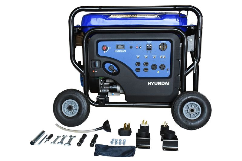 Generador a gasolina Hyundai de 11500 W, 22 HP y 110/220 V, vista frontal con accesorios y herramientas en la base