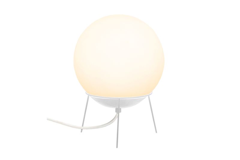 Luminaria de mesa Globb blanco lechoso 1L E27 Blumenau, encendida sobre base de tres patas con cable blanco