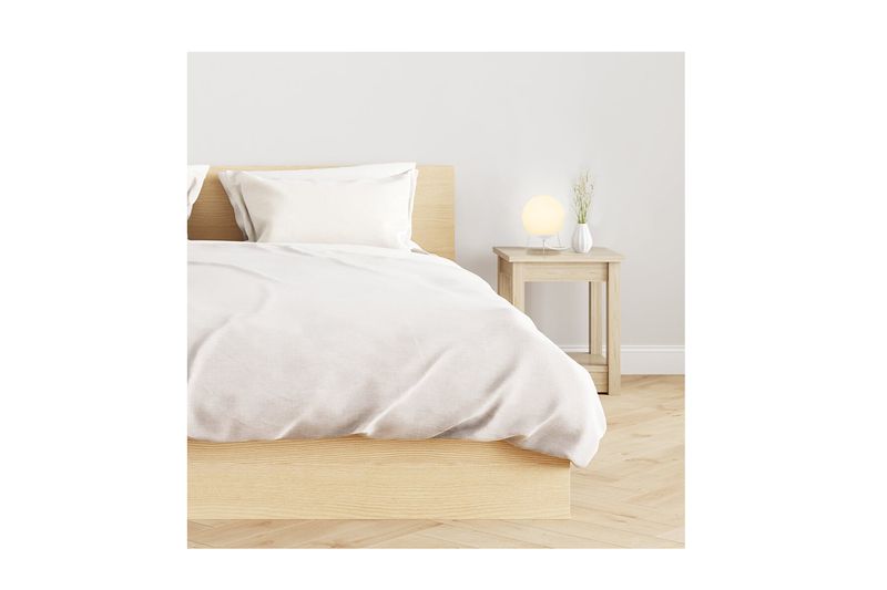 Luminaria de mesa Globb blanco lechoso 1L E27 Blumenau, encendida sobre una mesa de noche junto a una cama blanca