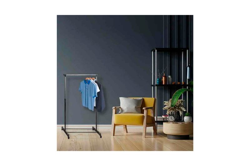 Perchero con ruedas regulable 84 x 42 x 165 cm Koopman, ambientado en habitación con camisas colgadas y sillón amarillo