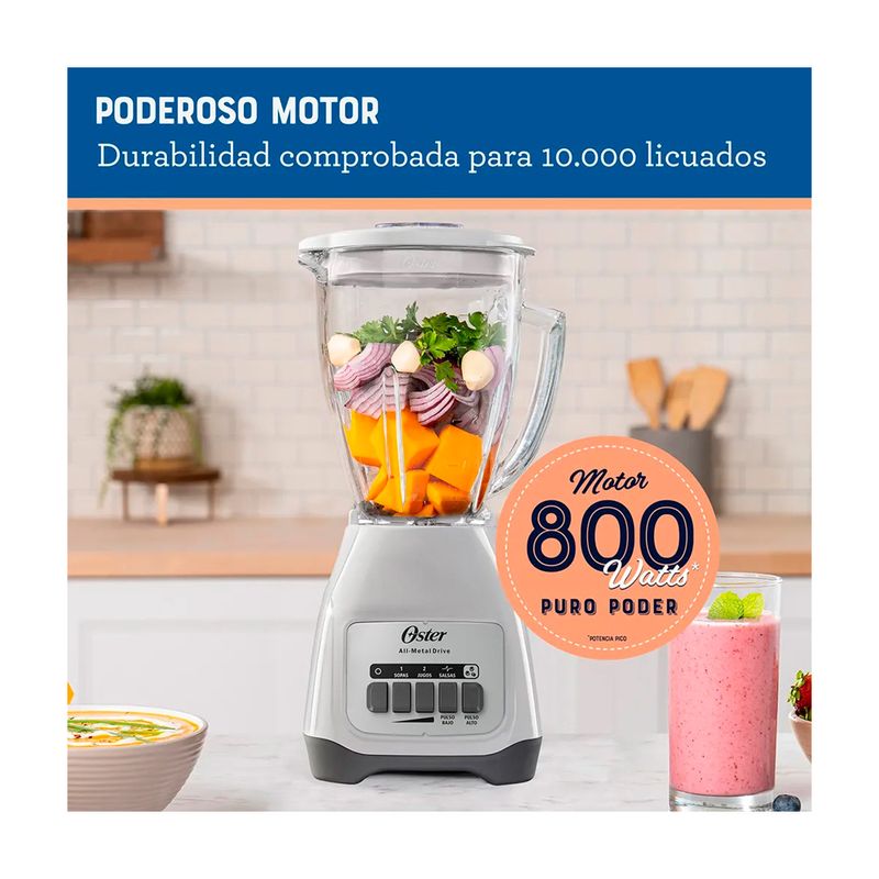 Licuadora vaso vidrio 1.5 L 800 W 2 vel blanca Oster, imagen promocional con ingredientes dentro del vaso y texto informativo