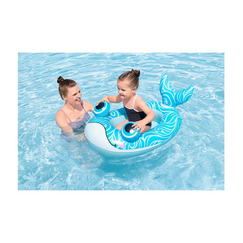 Flotador inflable para niños 3+ años Playa Pal Bestway, niña sentada sobre el inflable azul en forma de ballena