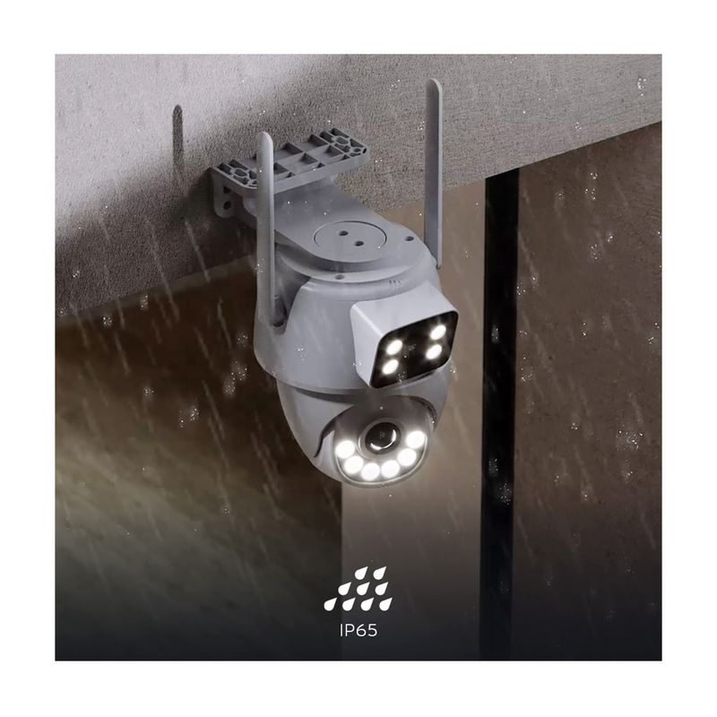 Cámara smart de exterior motorizada doble lente Nexxt, instalada en pared bajo la lluvia con sello IP65