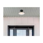 Luminaria de techo ext Alux 1L E27 60W negro Westinghouse, instalada en un techo blanco sobre una puerta negra