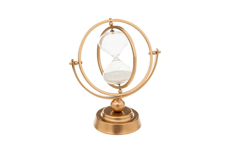 Reloj de arena decorativo metálico dorado de 23 cm Atmosphera, vista frontal sobre base circular con estructura esférica