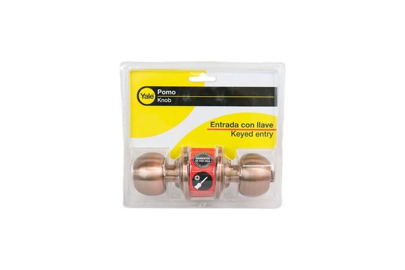 Cerradura pelota entrada Bolton Yale cobre, vista frontal en su empaque plástico con tarjeta amarilla