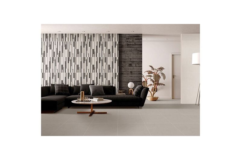 Porcelanato 60 x 60 Canova Ice Gris Carving Mate Sunhearrt, instalado en el piso de una sala moderna con sofá negro