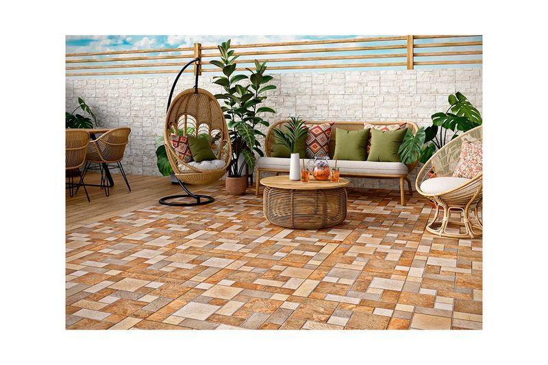 Baldosa 55x55 Donatto Mix rojo rústico mate Lamosa, ambientación de terraza exterior con muebles de mimbre y plantas