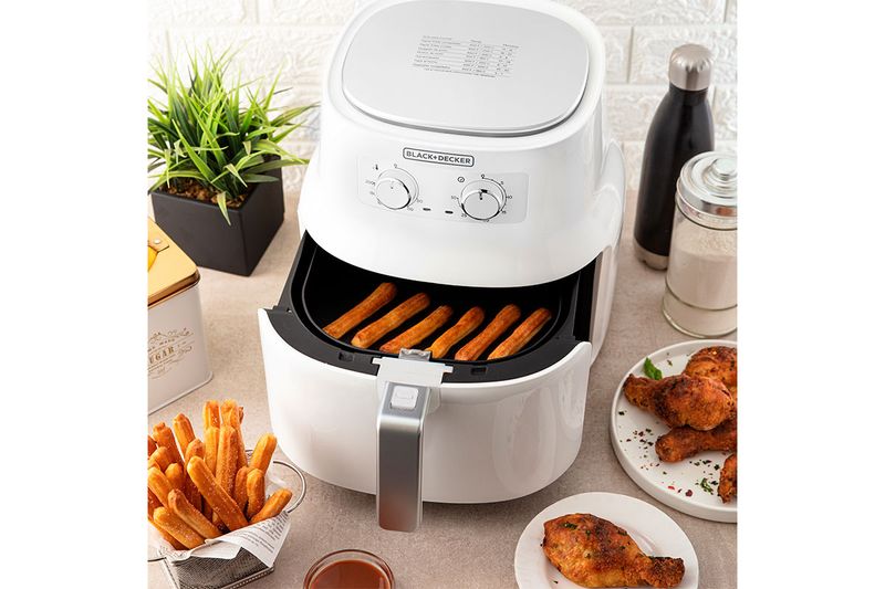 Freidora de aire grande 3.5 lts blanca Black+Decker, abierta con palitos de queso en su interior y acompañamientos